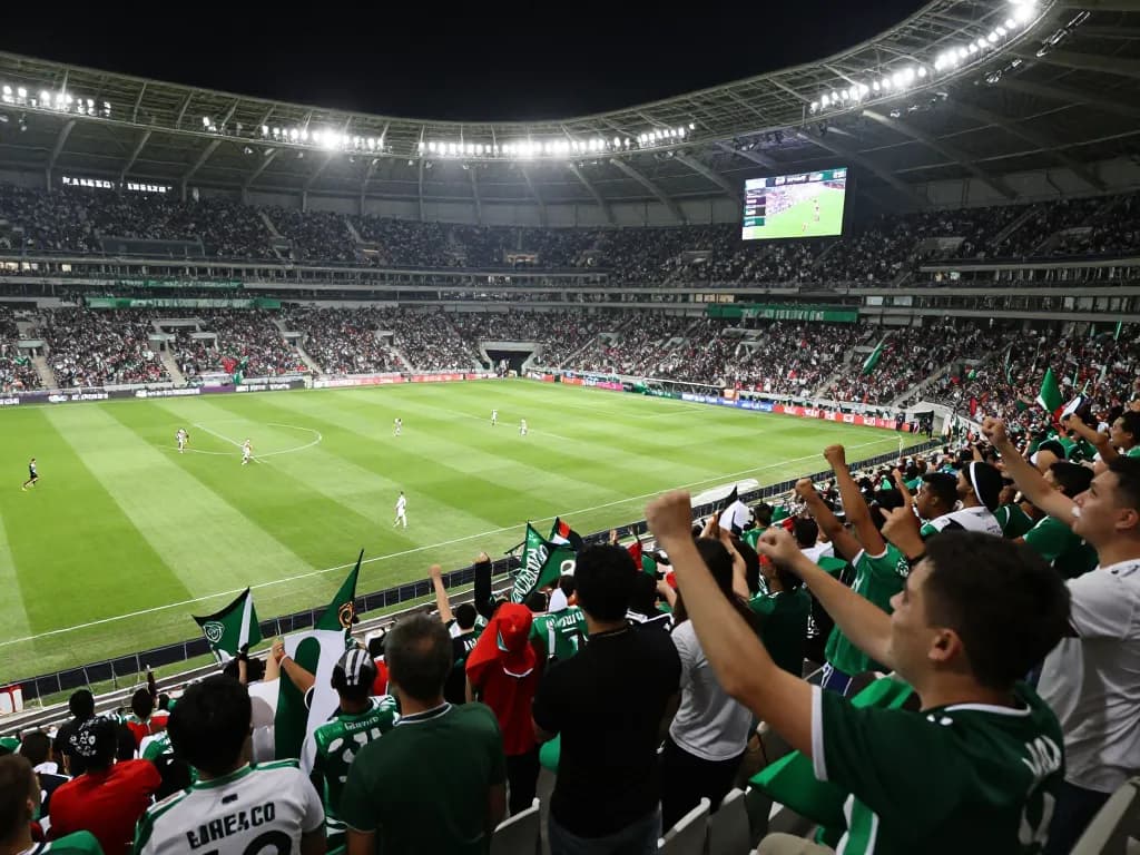 Excited fans at a soccer match celebrating tỷ lệ kèo bóng đá with banners and cheers.